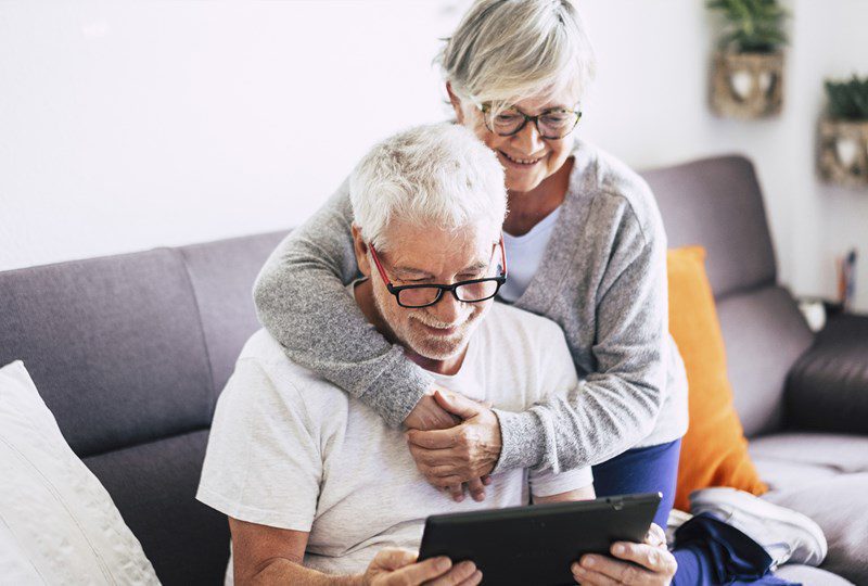 Senior couple on computer looking at two homes