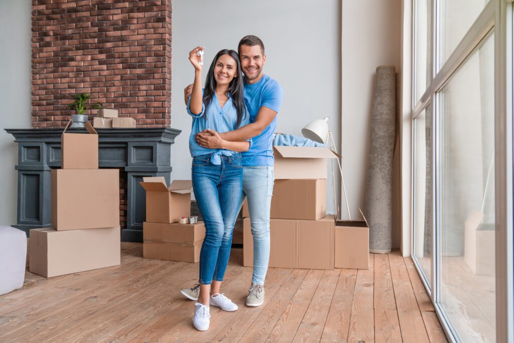 A young couple packing and preparing to move into a new home.